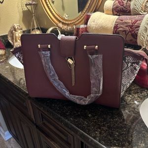 Burgundy Purse with small animal print on sides.